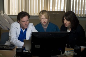Nate, Parker, and Sophie looking at a computer monitor